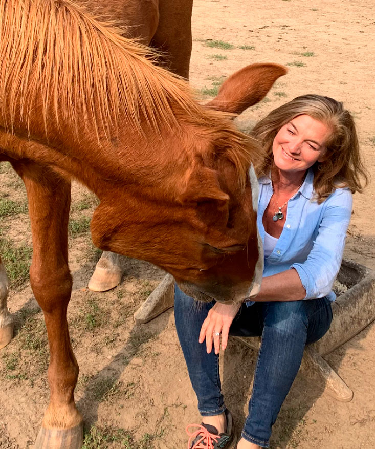 Michele Lawrence stroking a horse